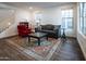 Spacious living room with wood floors, large windows, and stylish furnishings at 4381 E Rawhide St, Gilbert, AZ 85296