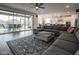 Open-concept living area with hardwood floors, comfortable seating, and view of the outdoor pool at 4381 E Rawhide St, Gilbert, AZ 85296