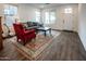 Bright living room with wood floors, comfortable seating, and a view of the front yard at 4381 E Rawhide St, Gilbert, AZ 85296