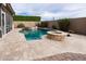 Backyard oasis with a pool, spa and fire pit, perfect for relaxation and outdoor entertaining at 4381 E Rawhide St, Gilbert, AZ 85296