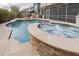 Resort-style pool with integrated spa and fire feature, surrounded by lush landscaping at 4381 E Rawhide St, Gilbert, AZ 85296