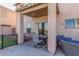 Covered back patio with outdoor seating, perfect for relaxing and enjoying the backyard view at 45608 W Barbara Ln, Maricopa, AZ 85139