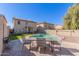 Enjoy outdoor dining poolside on the backyard patio, complete with artificial turf and secure fencing at 45608 W Barbara Ln, Maricopa, AZ 85139