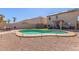 A private kidney-shaped pool is surrounded by rock landscaping and patio seating, perfect for outdoor relaxation at 45608 W Barbara Ln, Maricopa, AZ 85139