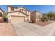 Inviting home with an attached two-car garage, desert landscaping, and a spacious driveway at 45608 W Barbara Ln, Maricopa, AZ 85139
