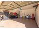 A spacious garage features ample storage solutions with organized shelves, cabinets, and tool racks at 45608 W Barbara Ln, Maricopa, AZ 85139