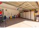 An organized garage with overhead storage and wall-mounted cabinets provides ample space for projects and storage at 45608 W Barbara Ln, Maricopa, AZ 85139