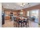 Well-appointed kitchen featuring wooden cabinets, an island, and a sliding glass door leading to the outdoor patio at 45608 W Barbara Ln, Maricopa, AZ 85139