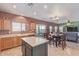 Charming kitchen featuring an island, stainless steel appliances, and an eat-in dining area at 45608 W Barbara Ln, Maricopa, AZ 85139