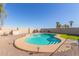 Kidney shaped backyard pool with turf, block wall, and small patio area at 45608 W Barbara Ln, Maricopa, AZ 85139