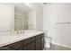 Bathroom with a white countertop, dark wood cabinets, a large mirror, and a toilet at 5100 E Rancho Paloma Dr # 2061, Cave Creek, AZ 85331