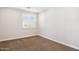 Bright bedroom with neutral carpeting, white walls, a window with blinds, and an electrical outlet at 5100 E Rancho Paloma Dr # 2061, Cave Creek, AZ 85331
