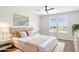 Comfortable bedroom featuring a ceiling fan, neutral color palette, white shutters and beautiful natural light at 5100 E Rancho Paloma Dr # 2061, Cave Creek, AZ 85331