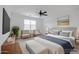 Bedroom is virtually staged with furniture, a TV, and neutral decor at 7109 E Gamebird Way, San Tan Valley, AZ 85143
