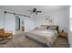 Staged bedroom features a ceiling fan and sliding barn door to ensuite bath at 7109 E Gamebird Way, San Tan Valley, AZ 85143