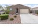 Single-story home with a two car garage and low maintenance desert landscaping at 7109 E Gamebird Way, San Tan Valley, AZ 85143