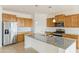 Bright kitchen with island, granite countertops, and stainless steel appliances at 7109 E Gamebird Way, San Tan Valley, AZ 85143