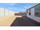 View of a home's backyard with block wall, gravel, and potential for outdoor living space at 7417 W Buckhorn Trl, Peoria, AZ 85383