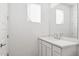 Modern bathroom featuring a large mirror, vanity with white countertop, and brushed nickel faucet at 7417 W Buckhorn Trl, Peoria, AZ 85383