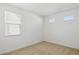 Bright bedroom featuring neutral carpet, white walls, and natural light from multiple windows with modern blinds at 7417 W Buckhorn Trl, Peoria, AZ 85383