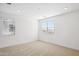 Well-lit bedroom with two windows, neutral carpet, and white walls for a calming atmosphere at 7417 W Buckhorn Trl, Peoria, AZ 85383