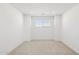 Bright bedroom featuring neutral carpet, recessed lighting, and a large window with blinds at 7417 W Buckhorn Trl, Peoria, AZ 85383