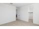 Spacious bedroom with neutral carpet and a view to the stairwell at 7417 W Buckhorn Trl, Peoria, AZ 85383