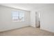 A bright bedroom features neutral carpet and a large window at 7417 W Buckhorn Trl, Peoria, AZ 85383