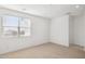 Bright bedroom featuring neutral carpet, recessed lighting, and a large window with blinds at 7417 W Buckhorn Trl, Peoria, AZ 85383