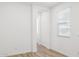 Bright, light-filled bedroom featuring a window, white walls, and wood-look vinyl plank flooring at 7417 W Buckhorn Trl, Peoria, AZ 85383