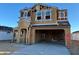 Two-story home under construction featuring a spacious two car garage and a porch at 7417 W Buckhorn Trl, Peoria, AZ 85383