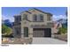 Charming two-story home featuring a neutral gray facade and a two-car garage, set against a picturesque mountain backdrop at 7417 W Buckhorn Trl, Peoria, AZ 85383