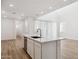 Kitchen with a large island featuring modern fixtures and a stainless steel dishwasher, flowing into an open living space at 7417 W Buckhorn Trl, Peoria, AZ 85383