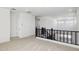 Open loft area with neutral carpet and modern railing, perfect for a secondary living space at 7417 W Buckhorn Trl, Peoria, AZ 85383