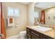 Well-lit bathroom features granite countertops, white sink, and a framed window at 8187 E Del Caverna Dr, Scottsdale, AZ 85258