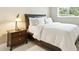 Cozy bedroom with a white comforter, wood-framed bed, and a bedside table at 8187 E Del Caverna Dr, Scottsdale, AZ 85258