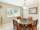 Bright dining area featuring a modern chandelier and a table with four chairs at 8187 E Del Caverna Dr, Scottsdale, AZ 85258