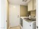 Laundry room featuring a washer, dryer, white cabinets, and a white door at 8187 E Del Caverna Dr, Scottsdale, AZ 85258