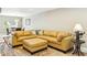 Bright living room with a large tan sectional couch and decorative rug at 8187 E Del Caverna Dr, Scottsdale, AZ 85258