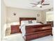 The primary bedroom featuring a ceiling fan, large bed, and ensuite bath at 8187 E Del Caverna Dr, Scottsdale, AZ 85258