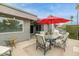 Outdoor patio with a dining table, chairs, and an umbrella for shade at 8187 E Del Caverna Dr, Scottsdale, AZ 85258