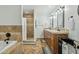 Well lit bathroom featuring double sinks, tiled shower and flooring, and a tub for a luxurious, spa-like experience at 902 W Claremont St, Phoenix, AZ 85013
