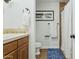 Neat bathroom with tiled shower and flooring, a comfort height toilet, and wood cabinets for a clean, functional space at 902 W Claremont St, Phoenix, AZ 85013