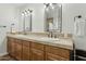 This spacious bathroom features double sinks with bronze fixtures, cabinets, and framed mirrors for a modern, clean look at 902 W Claremont St, Phoenix, AZ 85013