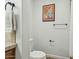 Cozy bathroom with tiled wall, contemporary towel rack and framed art at 902 W Claremont St, Phoenix, AZ 85013