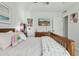 Bright bedroom features a wooden bed frame, whimsical decor, a mounted flat screen TV, and personal touches at 902 W Claremont St, Phoenix, AZ 85013