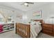 Bedroom featuring light, airy aesthetics with a wooden bed frame, whimsical decor, and plenty of natural light at 902 W Claremont St, Phoenix, AZ 85013