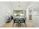 Elegant dining room featuring a modern chandelier, glass table, and an adjacent serving area at 902 W Claremont St, Phoenix, AZ 85013