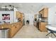 Spacious kitchen featuring tile floors, light wood cabinets, and modern appliances with granite countertops at 902 W Claremont St, Phoenix, AZ 85013