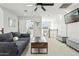 Spacious living area with a comfortable sofa, modern coffee table, and a mounted TV that enhances the space's versatility at 902 W Claremont St, Phoenix, AZ 85013